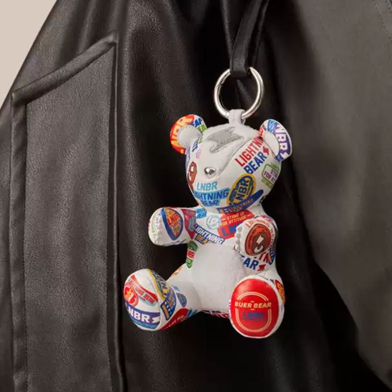 12cm BUERBEAR plush charm hanging on a handbag as a stylish accessory.